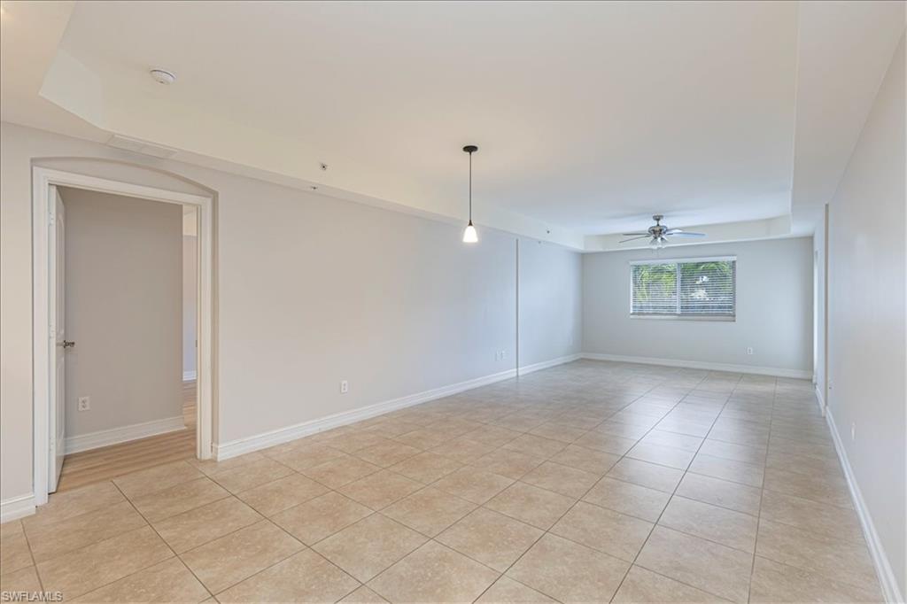 1100 Pine Ridge Road, Unit B106 Naples, FL 34108 - Photo 9 of 10 Empty room featuring light tile patterned floors and a ceiling fan