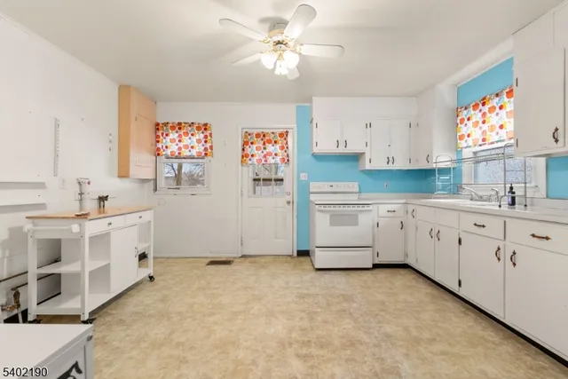 a kitchen with cabinets stove top oven and sink