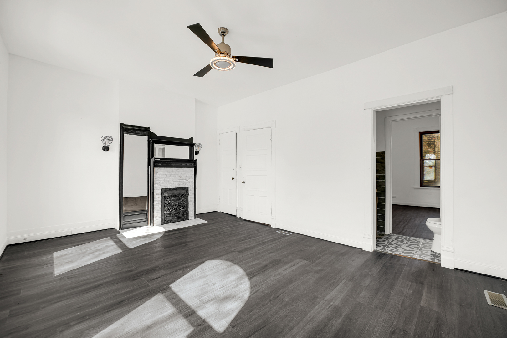928 East 46th Street Chicago, IL 60653 - Photo 12 of 25 an empty room with wooden floor closet and windows