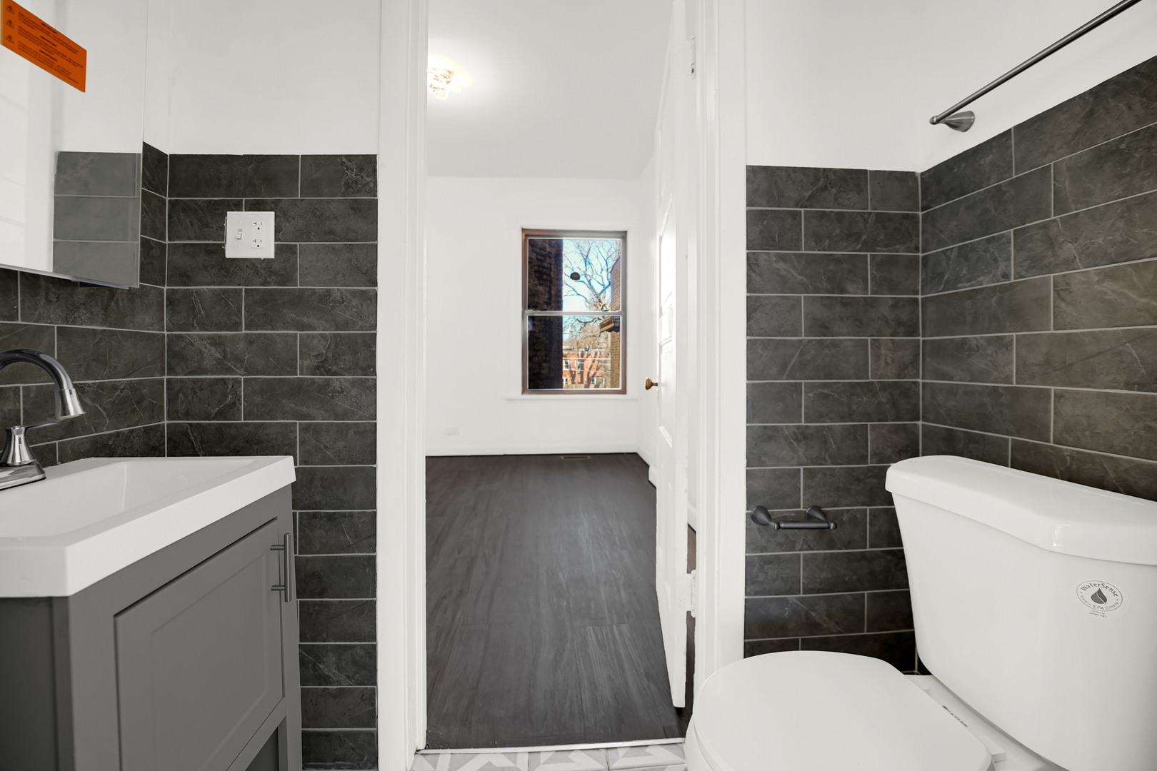 928 East 46th Street Chicago, IL 60653 - Photo 13 of 25 a bathroom with a toilet a sink and mirror