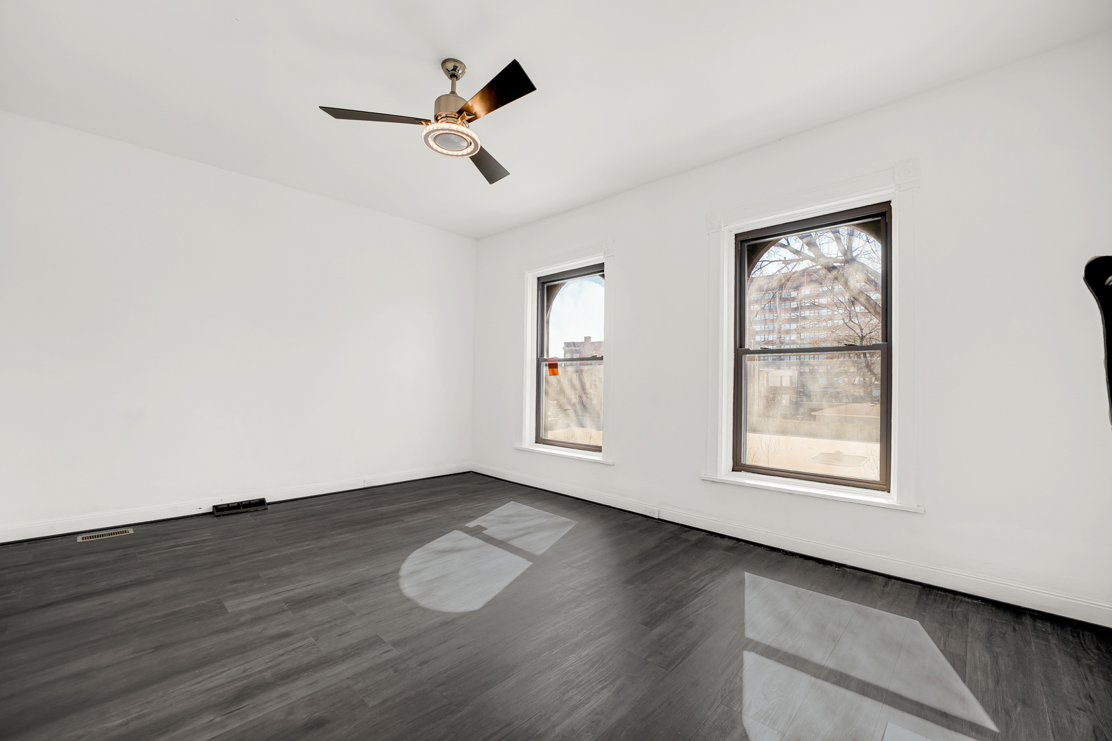 928 East 46th Street Chicago, IL 60653 - Photo 14 of 25 a view of an empty room with wooden floor and a window