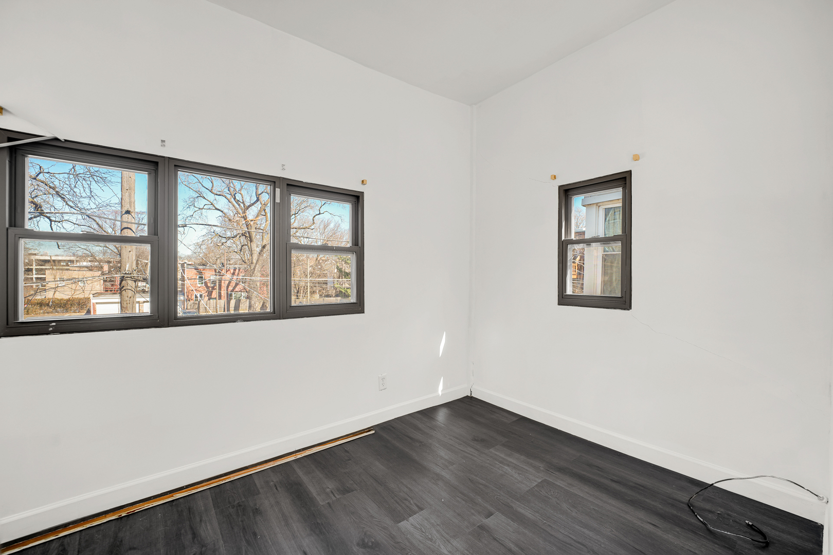 928 East 46th Street Chicago, IL 60653 - Photo 20 of 25 an empty room with wooden floor and windows