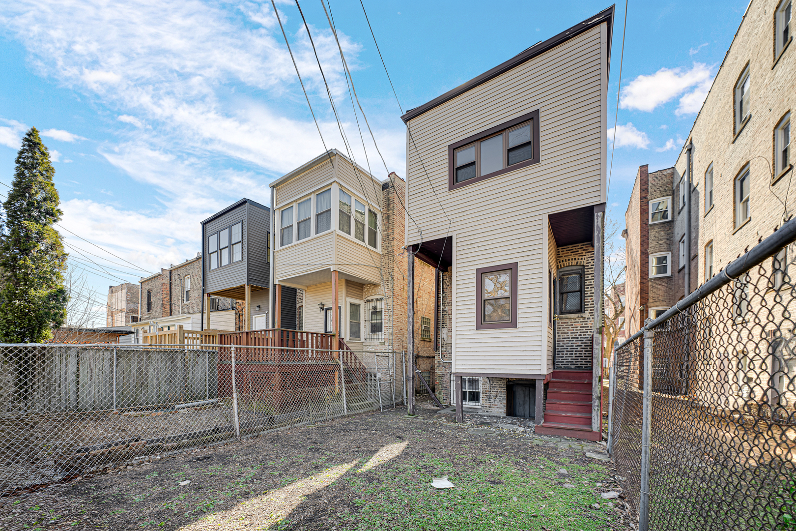 928 East 46th Street Chicago, IL 60653 - Photo 22 of 25 a view of a brick house with many windows next to a yard