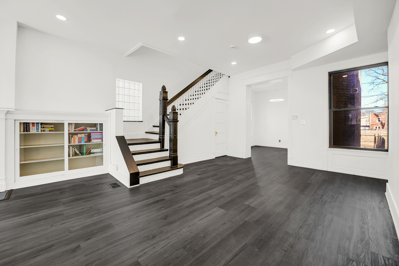 928 East 46th Street Chicago, IL 60653 - Photo 3 of 25 a view of a livingroom with wooden floor and stairs
