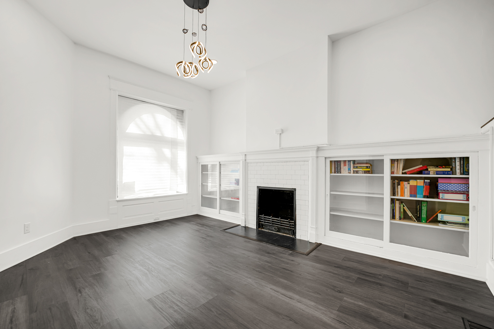 928 East 46th Street Chicago, IL 60653 - Photo 4 of 25 a view of an empty room with a window and fireplace