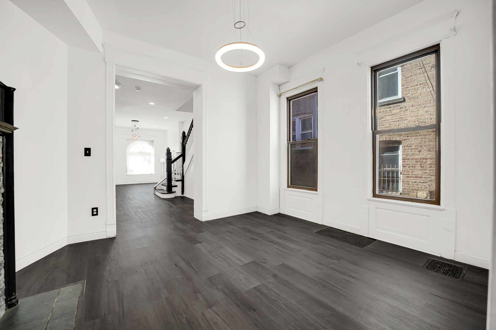 928 East 46th Street Chicago, IL 60653 - Photo 6 of 25 an empty room with wooden floor and windows