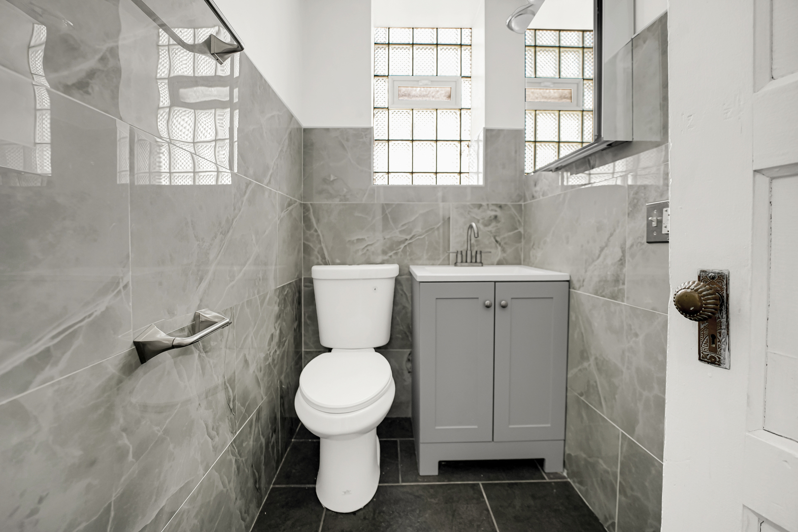 928 East 46th Street Chicago, IL 60653 - Photo 10 of 25 a white toilet sitting next to a bathroom sink
