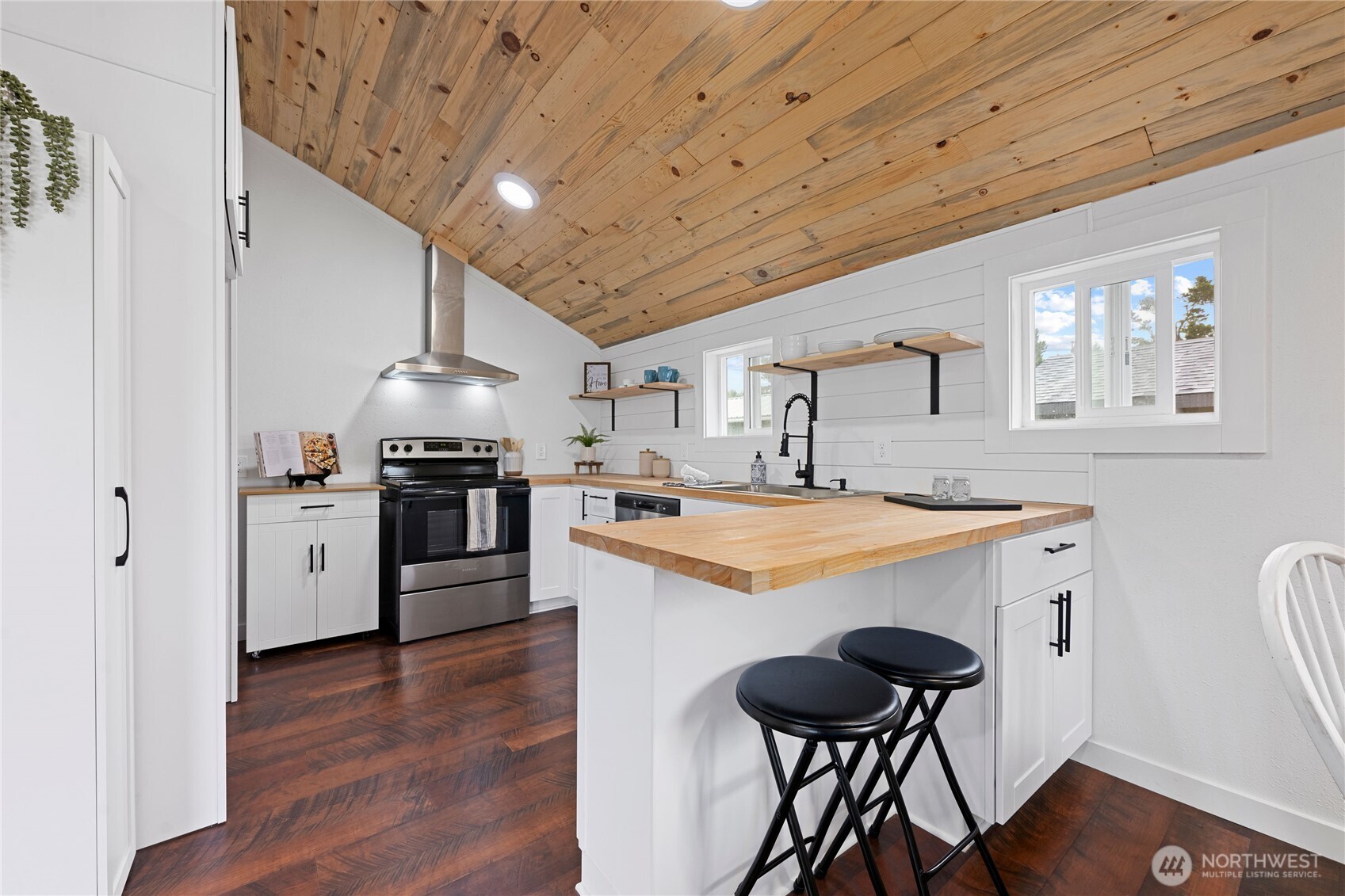 26502 Ridge Avenue Ocean Park, WA 98640 - Photo 12 of 30 a kitchen with stainless steel appliances a stove a sink dishwasher and a refrigerator
