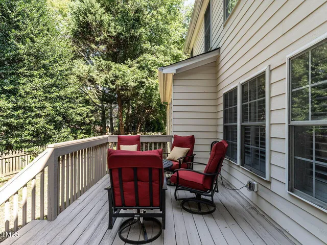 a view of balcony with wooden floor and outdoor seating