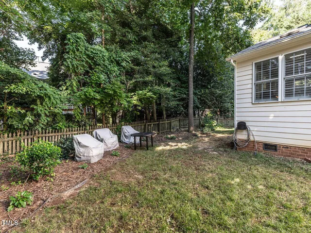 a view of a house with a yard and sitting area