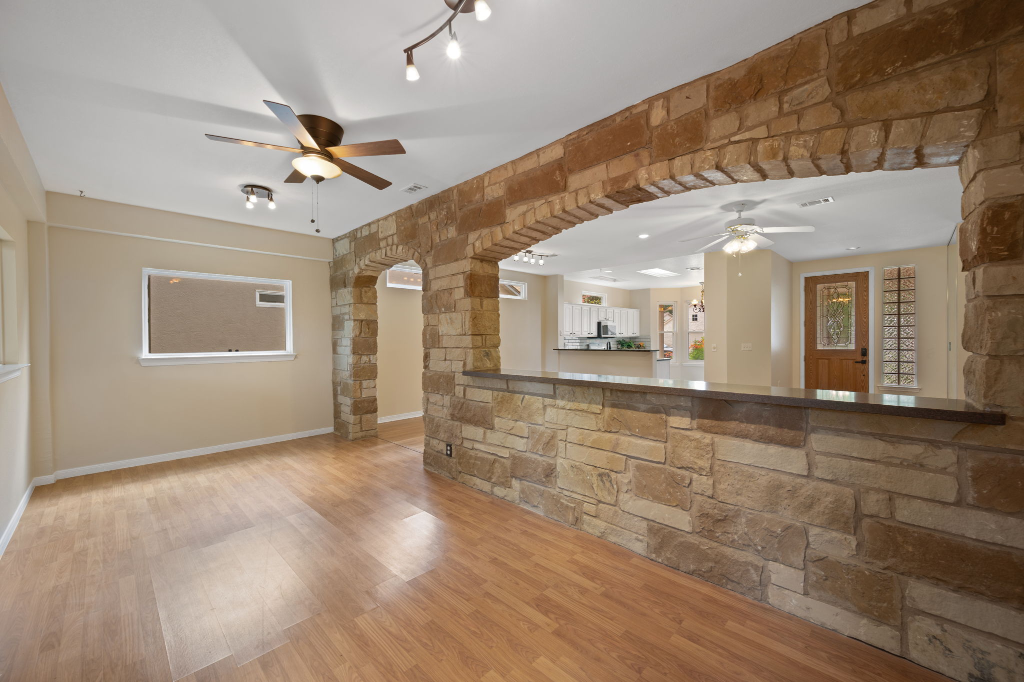 118 Bass Street Georgetown, TX 78633 - Photo 22 of 40 Wood flooring and stone archways define the inviting living spaces.