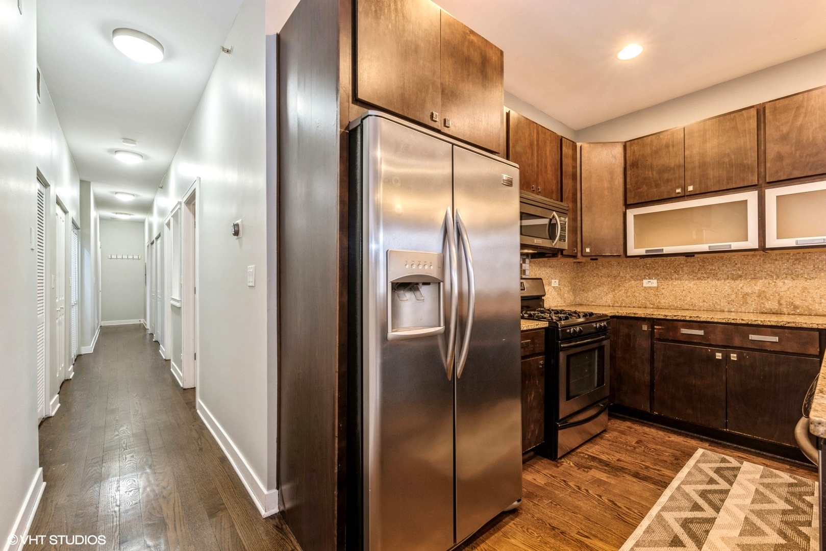 7932 West Grand Avenue, Unit 2W Elmwood Park, IL 60707 - Photo 20 of 22 a kitchen with stainless steel appliances granite countertop a refrigerator and a sink