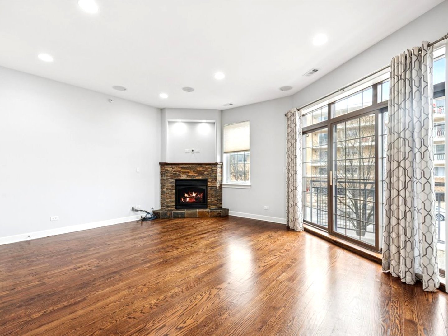 7932 West Grand Avenue, Unit 2W Elmwood Park, IL 60707 - Photo 4 of 22 wooden floor in an empty room with a fireplace