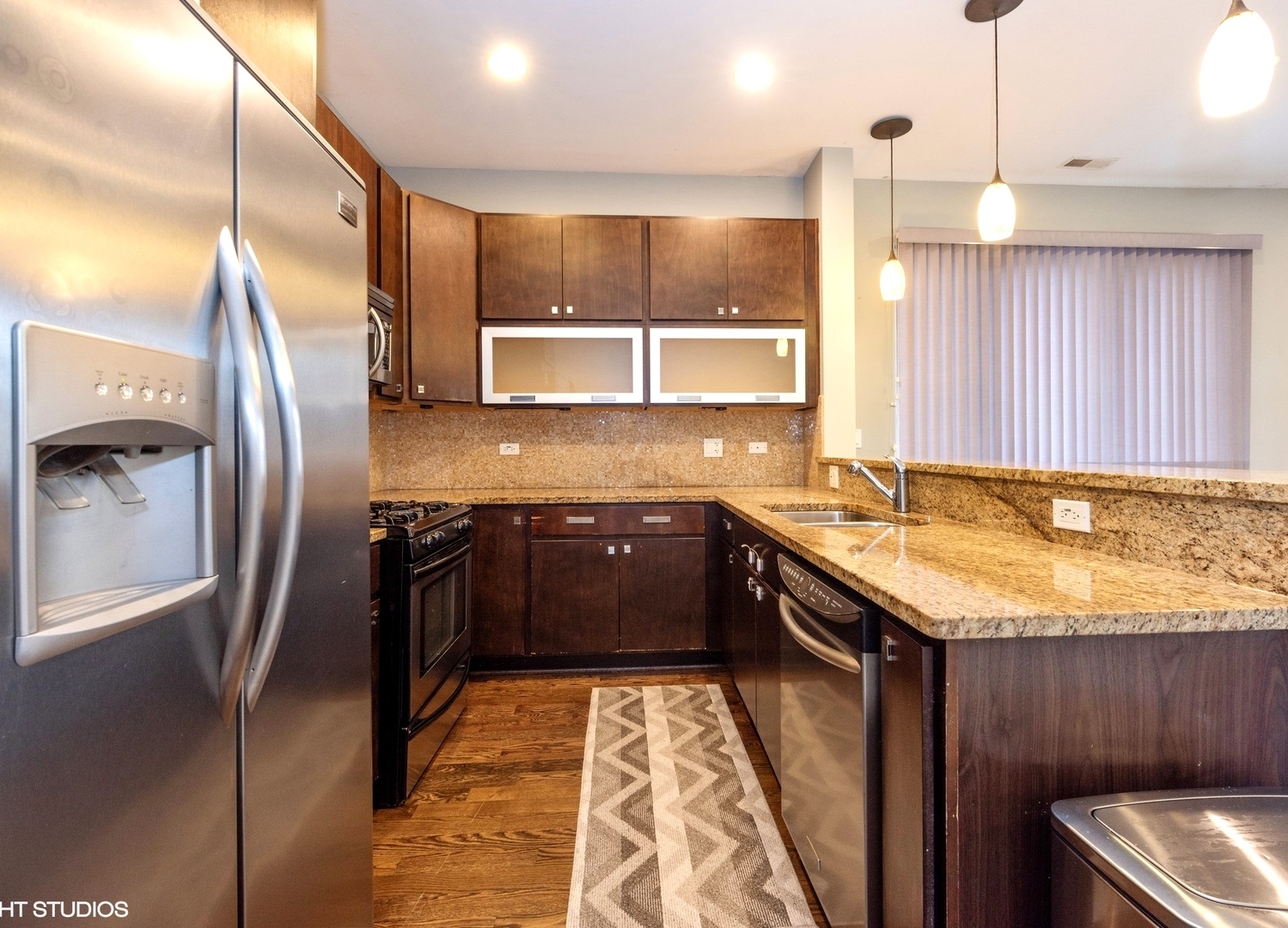 7932 West Grand Avenue, Unit 2W Elmwood Park, IL 60707 - Photo 5 of 22 a kitchen with stainless steel appliances granite countertop a sink stove and refrigerator