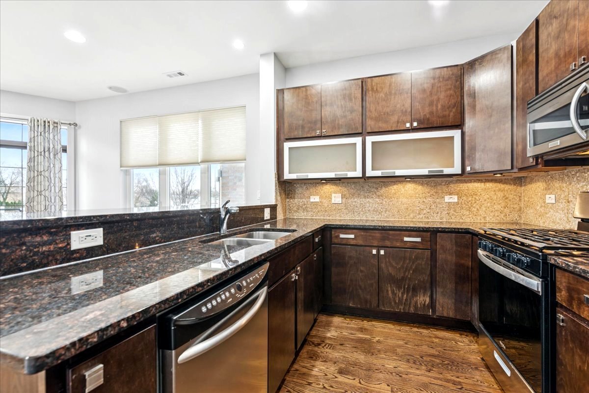 7932 West Grand Avenue, Unit 2W Elmwood Park, IL 60707 - Photo 8 of 22 a kitchen with granite countertop a sink stove and cabinets