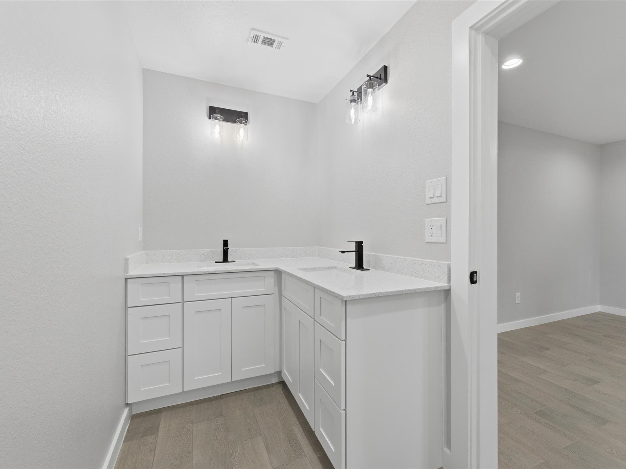 308 South 11th Street Conroe, TX 77301 - Photo 15 of 24 a spacious bathroom with a double vanity sink and mirror