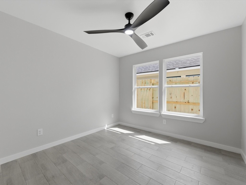 308 South 11th Street Conroe, TX 77301 - Photo 16 of 24 an empty room with wooden floor and windows