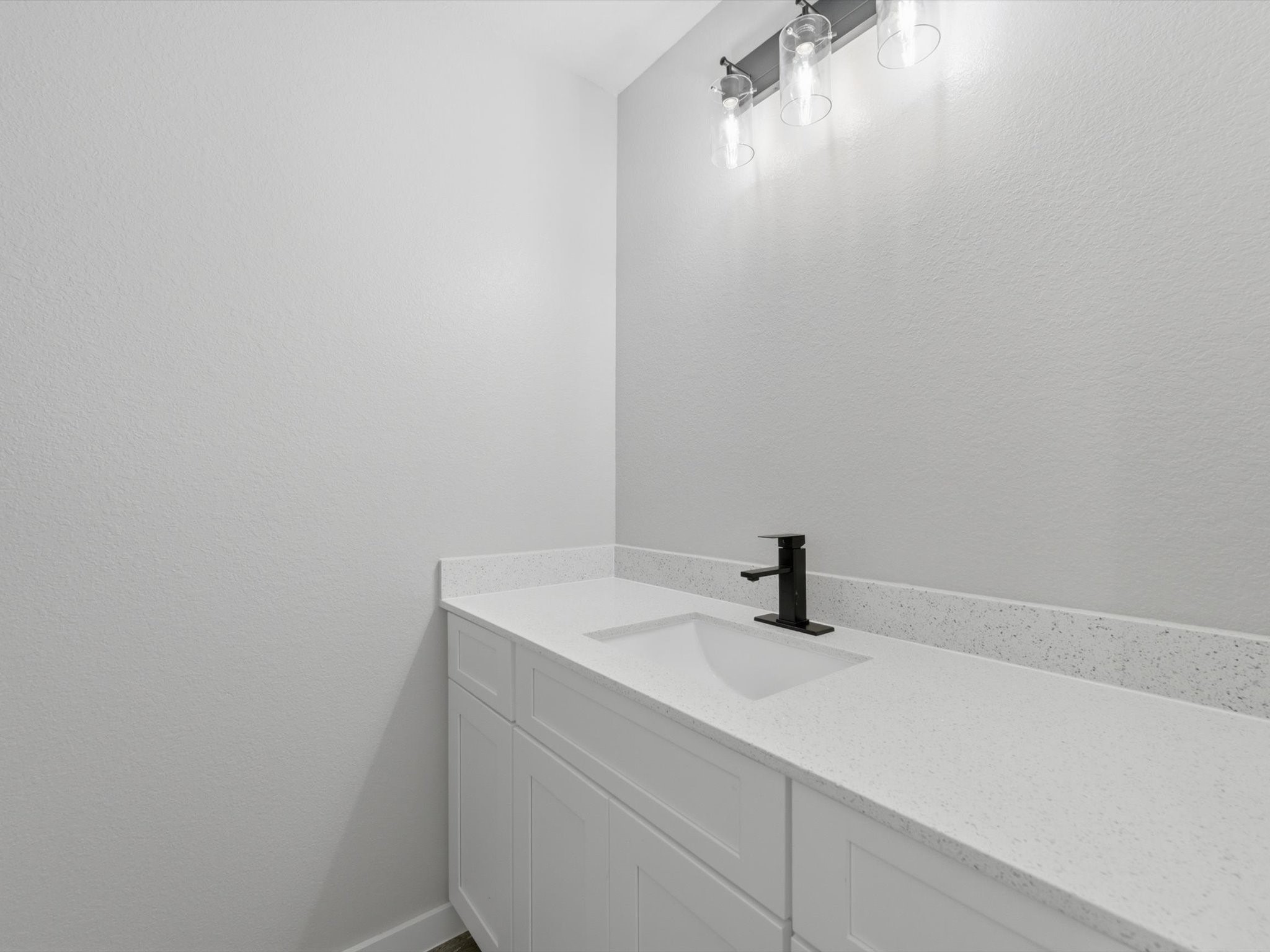 308 South 11th Street Conroe, TX 77301 - Photo 18 of 24 a bathroom with a sink and mirror