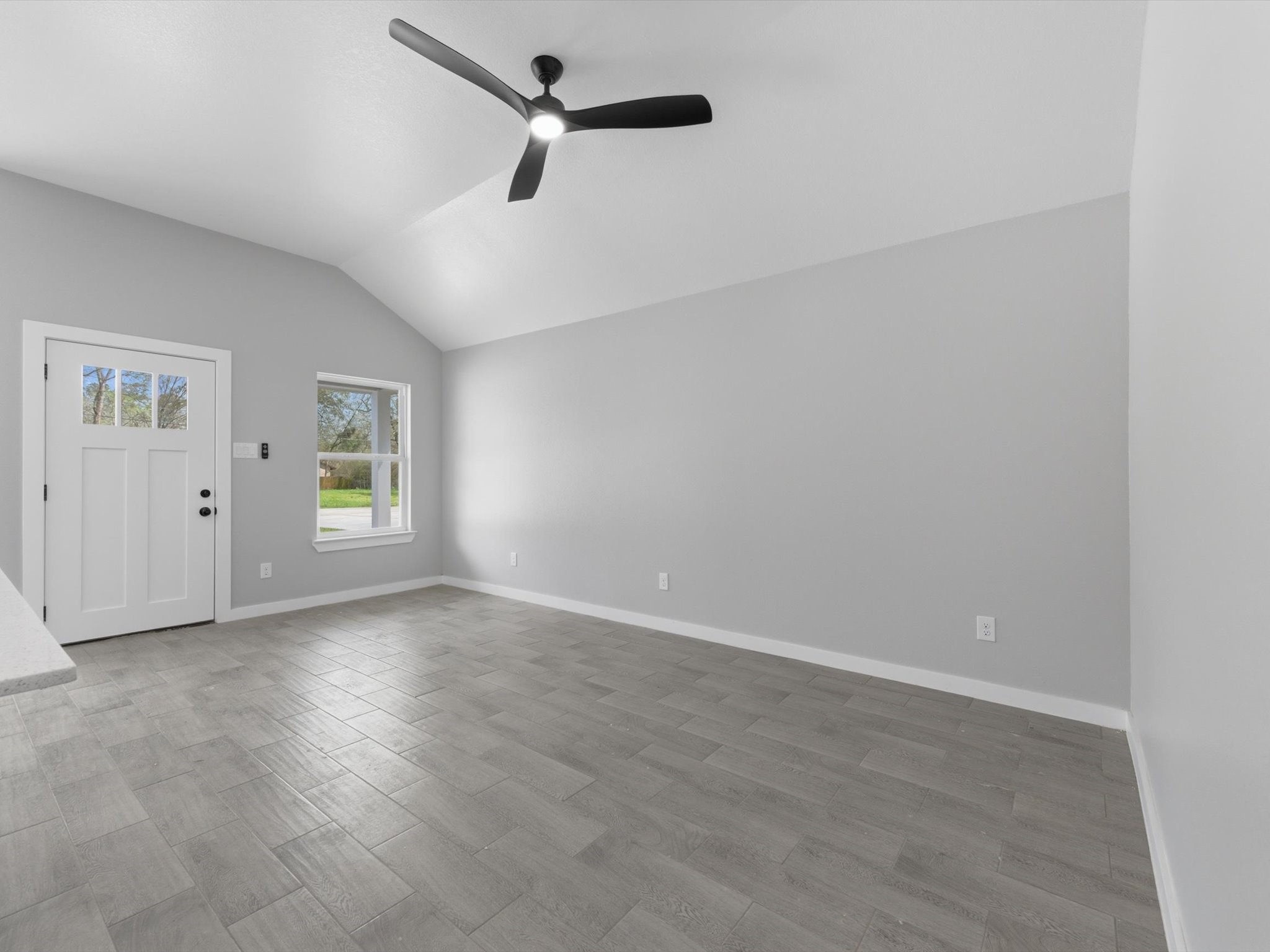308 South 11th Street Conroe, TX 77301 - Photo 5 of 24 an empty room with windows and ceiling fan