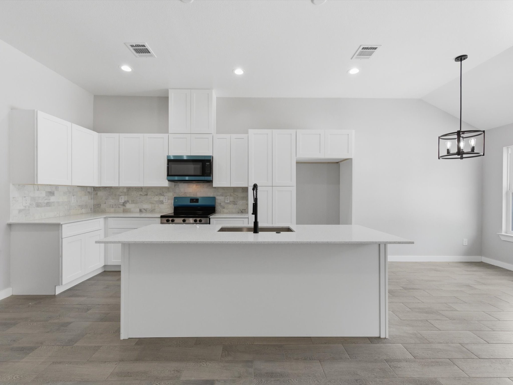 308 South 11th Street Conroe, TX 77301 - Photo 8 of 24 a kitchen with stainless steel appliances a stove top oven a sink a refrigerator and white cabinets