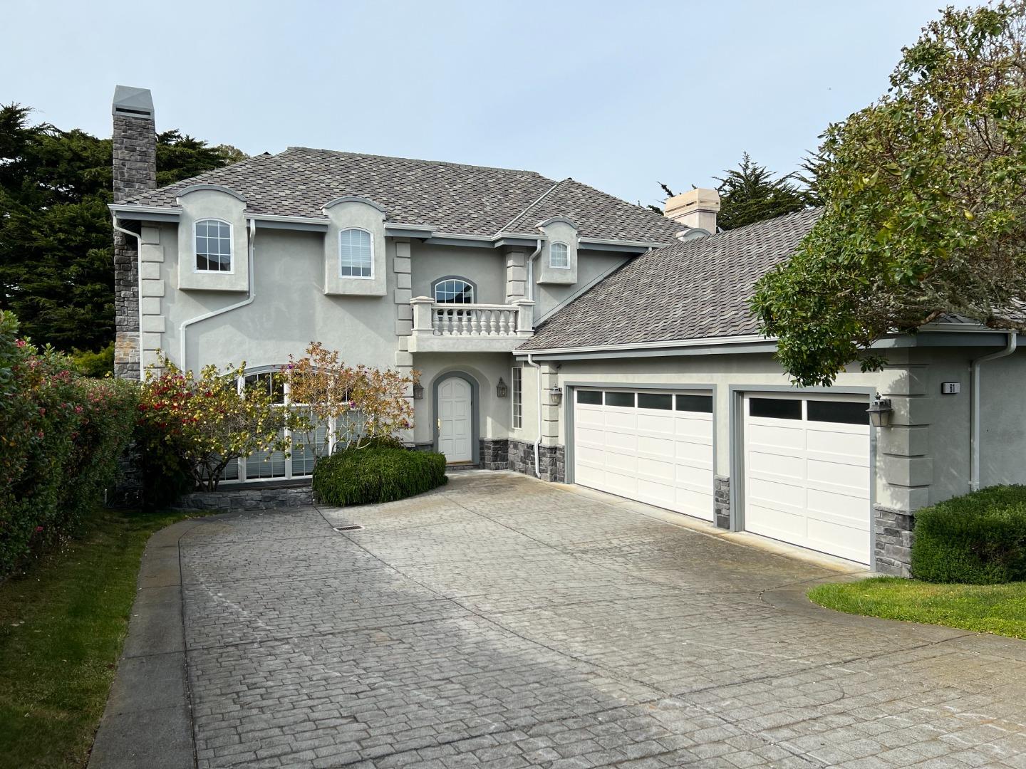61 Turnberry Road Half Moon Bay, CA 94019 - Photo 1 of 6 a front view of a house with a yard and garage