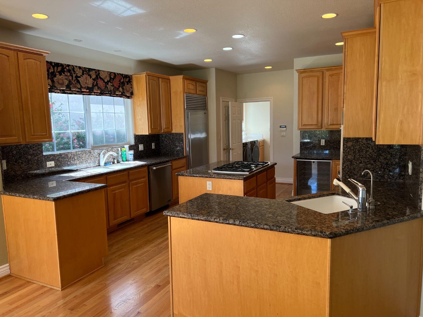 61 Turnberry Road Half Moon Bay, CA 94019 - Photo 2 of 6 a kitchen with granite countertop a sink a counter top space and stainless steel appliances