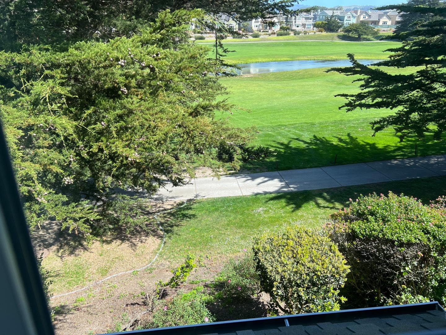 61 Turnberry Road Half Moon Bay, CA 94019 - Photo 4 of 6 a view of a garden with a lake