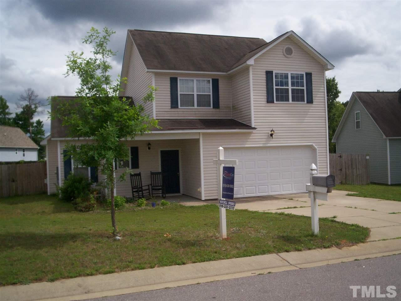 5320 Chipstone Drive Raleigh, NC 27610 - Photo 1 of 3 a front view of a house with a yard and garage