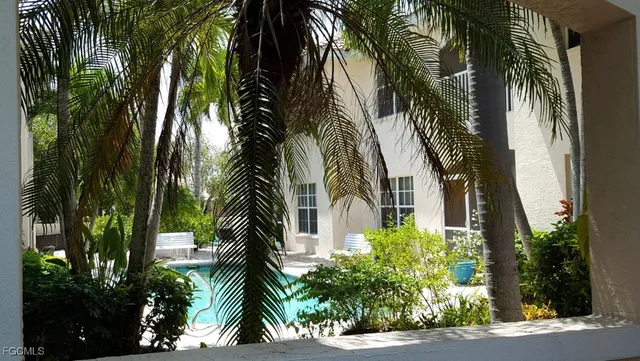 a couple of palm trees in front of house
