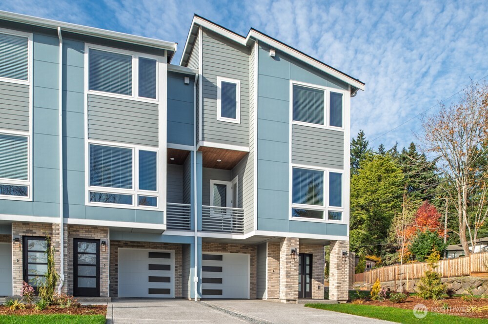 6611 South 128th Street Seattle, WA 98178 - Photo 1 of 20 a front view of a house with a garden