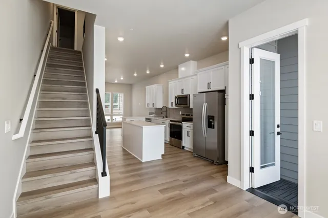 a view of a kitchen with cabinets and wooden floor