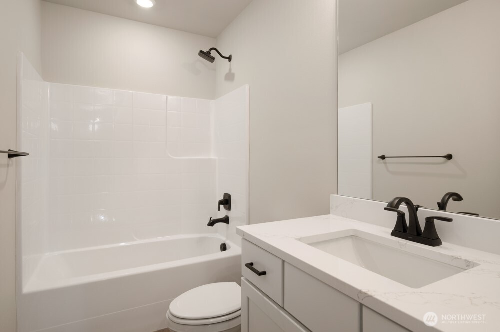 6611 South 128th Street Seattle, WA 98178 - Photo 14 of 20 a bathroom with a sink a toilet and bathtub