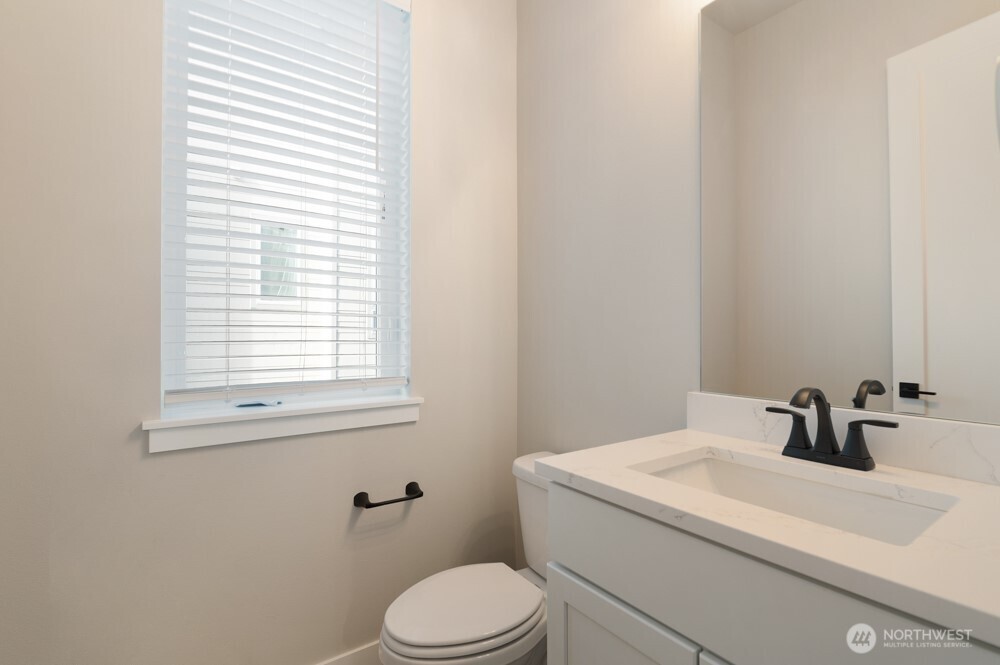 6611 South 128th Street Seattle, WA 98178 - Photo 4 of 20 a bathroom with a sink a toilet and a window