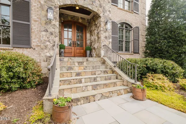 a front view of a house with potted plants