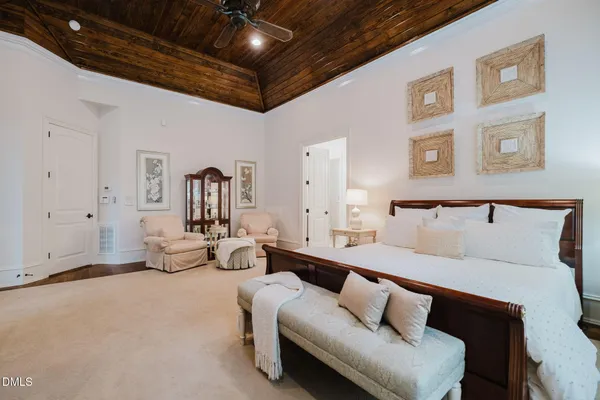 a bedroom with a bed and a lamp