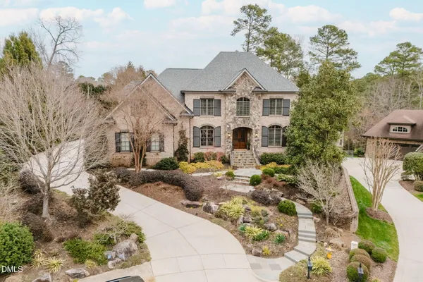 a view of a house with swimming pool and sitting area
