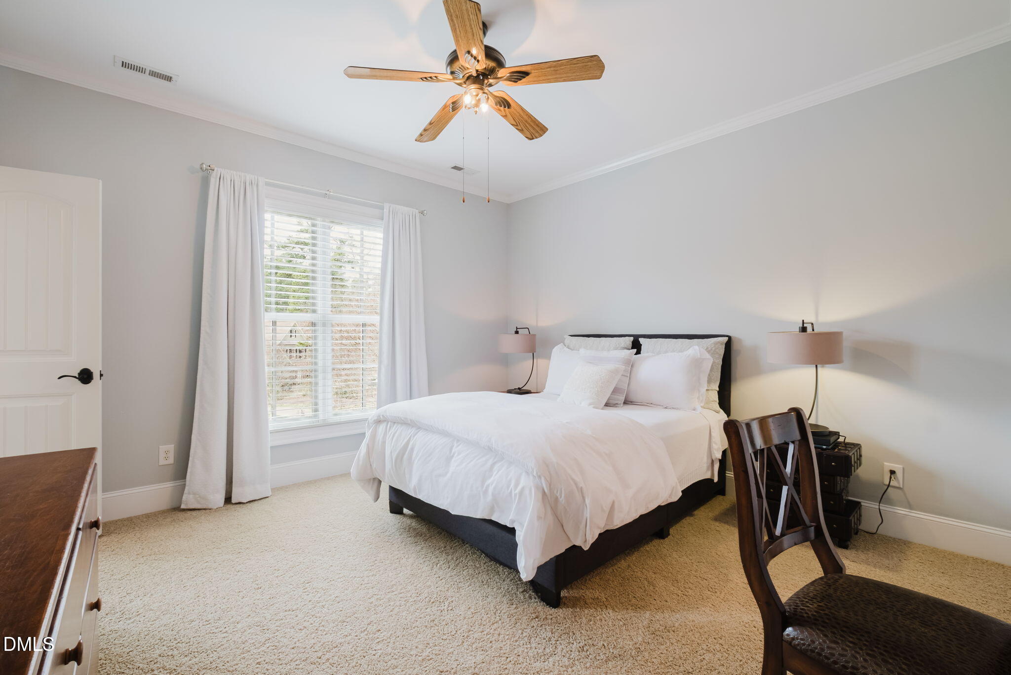 3604 Nightfall Court Raleigh, NC 27607 - Photo 48 of 79 a spacious bedroom with a bed and a chandelier