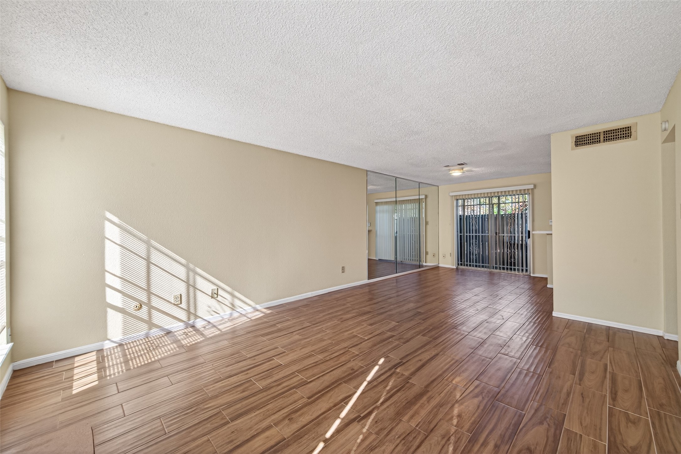 3100 Jeanetta Street, Unit 1004 Houston, TX 77063 - Photo 7 of 42 The living area is a study in fluidity, where warm-toned flooring and a bright palette create a seamless connection between the lounge and dining areas.