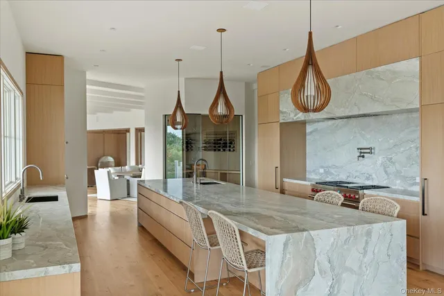 a large kitchen with kitchen island a large counter and a sink