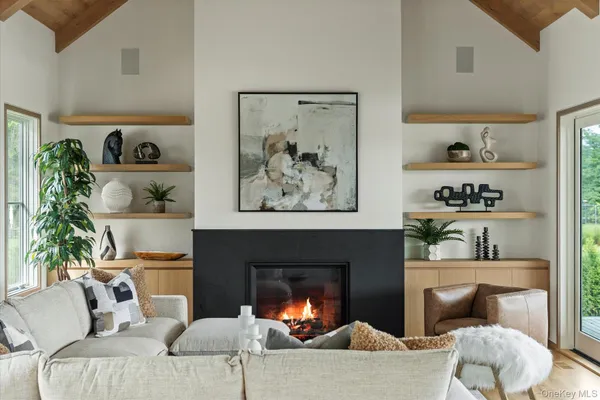 a hallway with wooden floor and staircase