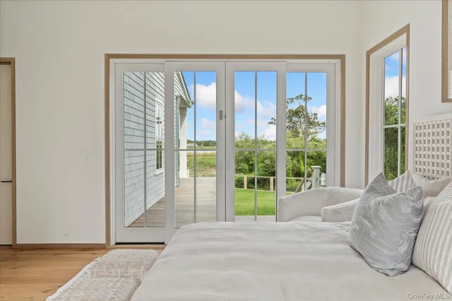 a view of a bedroom with a bed and wooden floor