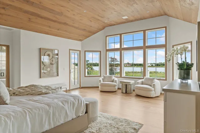 a spacious bedroom with a large bed and large window