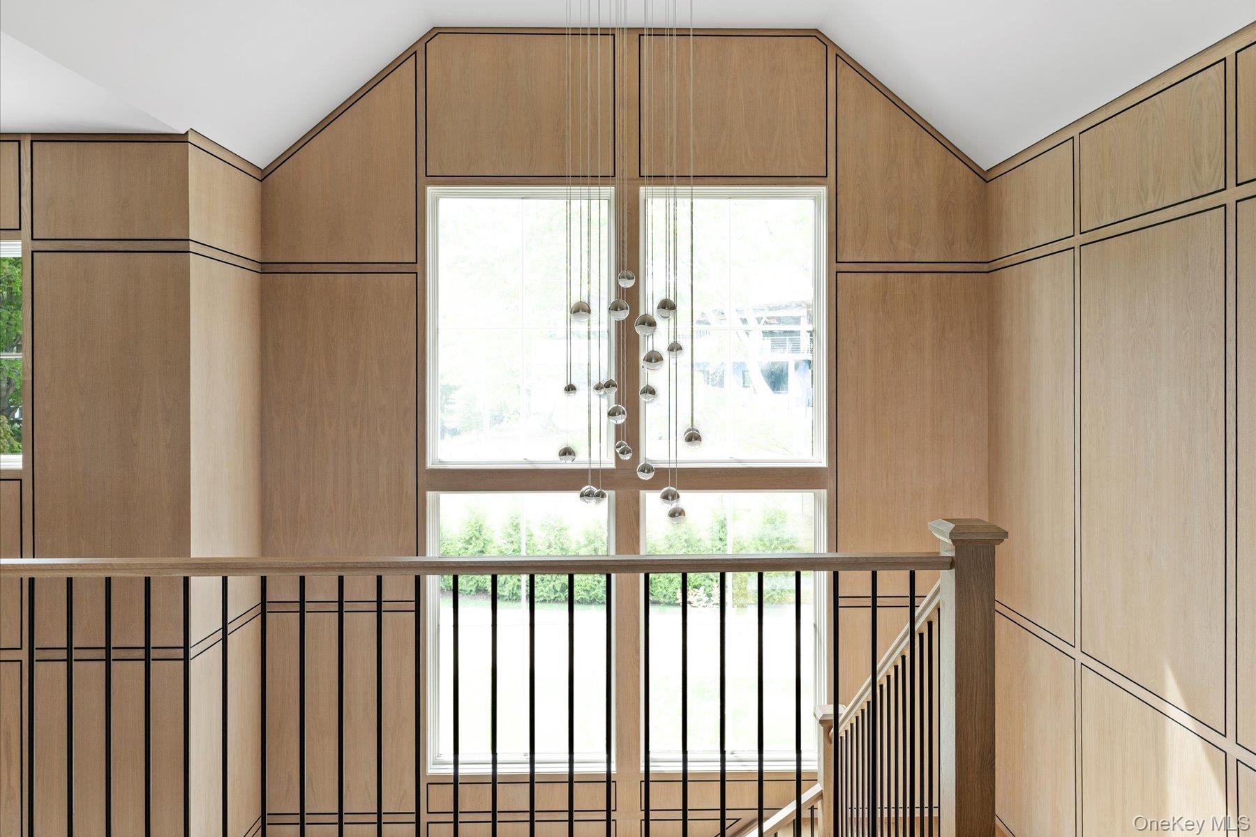 551 Main Street Quiogue, NY 11978 - Photo 26 of 50 Doorway to outside with healthy amount of natural light and vaulted ceiling