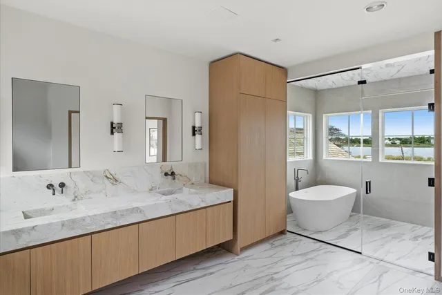 a bathroom with a granite countertop sink toilet a mirror and shower