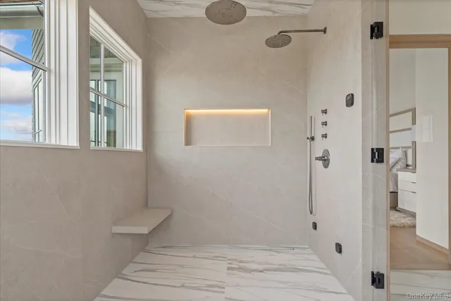 a bathroom with a granite countertop shower
