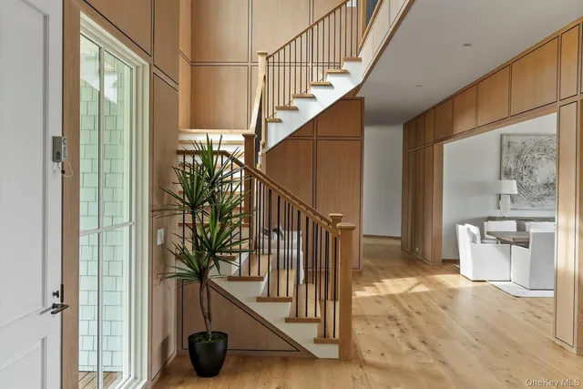 a view of entryway with wooden floor and windows