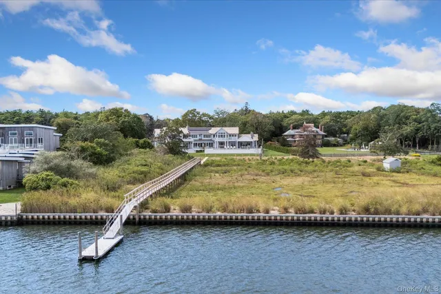a view of a swimming pool with a yard and sitting area