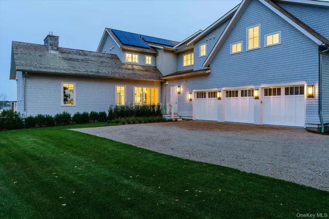 a view of a house with a yard and garage