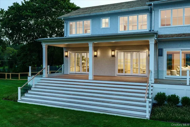 a view of a house with a small yard and a large window
