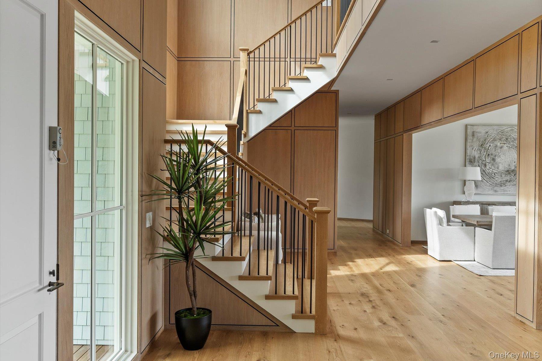 551 Main Street Quiogue, NY 11978 - Photo 5 of 50 Foyer with stairs, light wood-style floors, and a high ceiling
